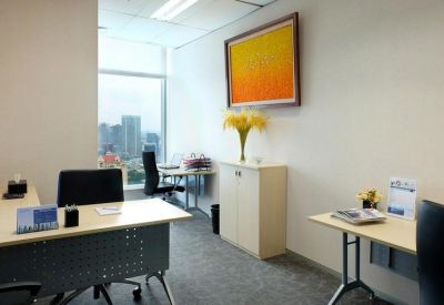 Bright private office suite with a wooden desk and vibrant yellow artwork.