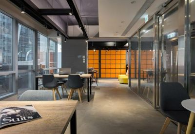 Contemporary cafe-style lounge with bar stools and a stylish geometric light fixture.