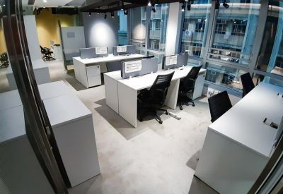 Large professional meeting room with a white conference table and ceiling-mounted projector.