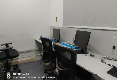 Dedicated workstation area featuring dual computer monitors and black mesh chairs.