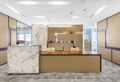 Elegant reception area featuring a marble front desk and warm wood accents.