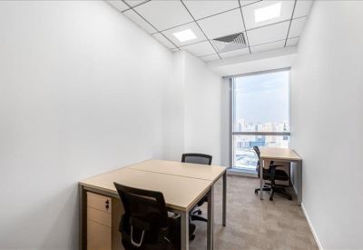 Bright private office suite with two workstations and a large window.