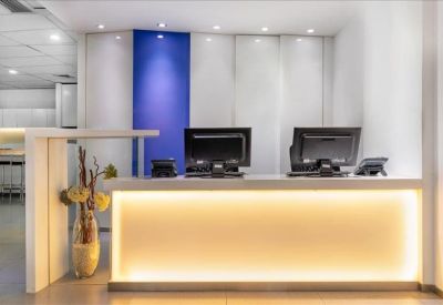 Reception desk area featuring warm under-counter lighting and a blue accent panel.