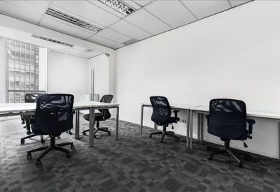 Bright four-person private office suite with grey patterned carpet.