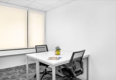 Private internal office suite with white desks and two black mesh chairs.