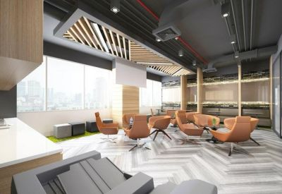 Casual breakout area with orange leather armchairs and contemporary lighting.