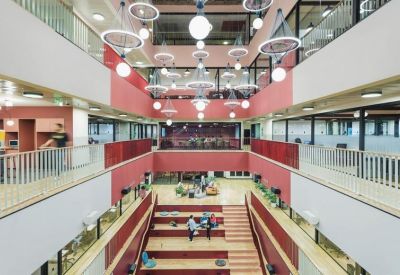 Multi-level atrium with hanging globe lights and red accent walls.