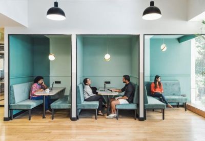 Semi-private teal booths for focused work or small team meetings.