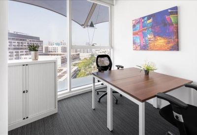 Private two-person office suite with floor-to-ceiling windows and colorful wall art.