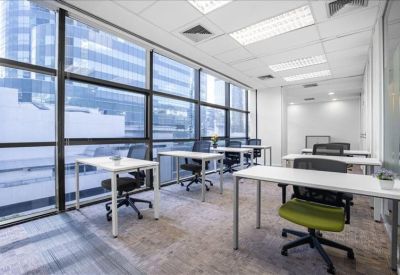 Modern communal kitchen and breakout area featuring a white high-top counter and stools.