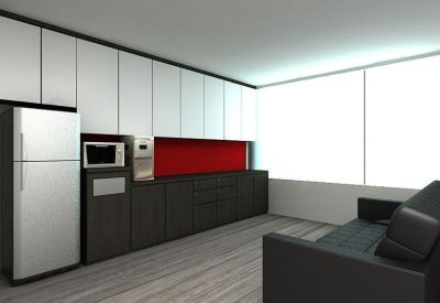 Modern communal kitchen and breakout area with red backsplash and sleek cabinetry.