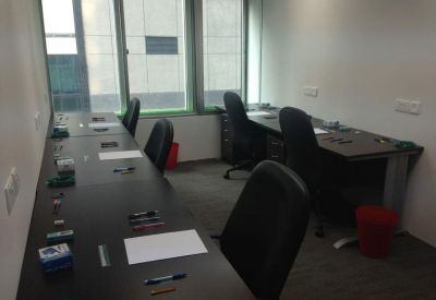 Bright private office suite featuring linear workstations and windows.