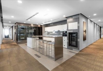 Communal kitchen area with a high breakfast bar and stools.