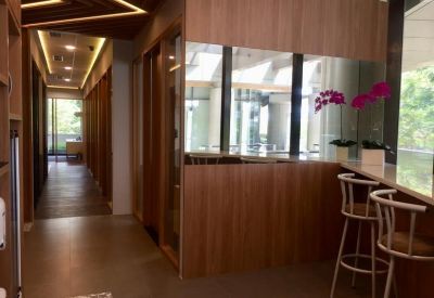 Building hallway showing the reception counter and high-backed bar stools near the window.