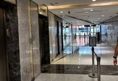 Lobby area with elevators and marble flooring.