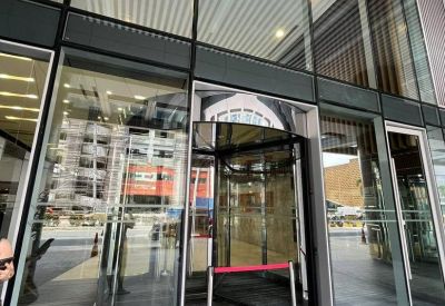 Revolving glass door entrance with red divider band.