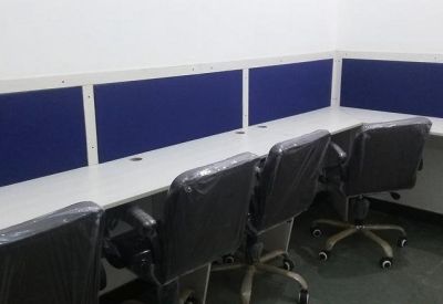 Private office workspace with three black leather chairs and blue privacy partitions.