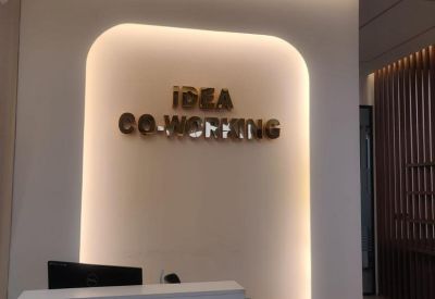 Reception desk area with backlit branding on a recessed wall.