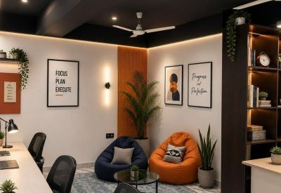 Relaxing breakout corner featuring colorful bean bags and leafy indoor plants.