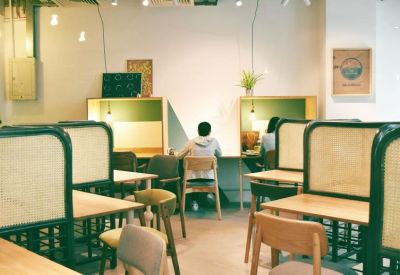 Quiet study area with individual workstations separated by light-toned screens.