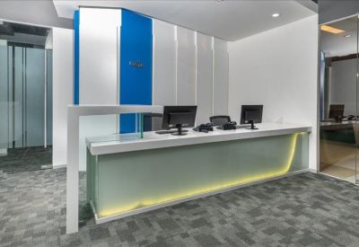 Modern reception desk with blue and white wall paneling and integrated lighting.