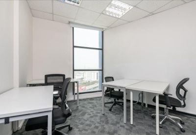 Bright private office with four white desks and a large window.
