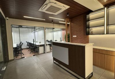 Minimalist reception area with a dark wood front desk and a brick feature wall.