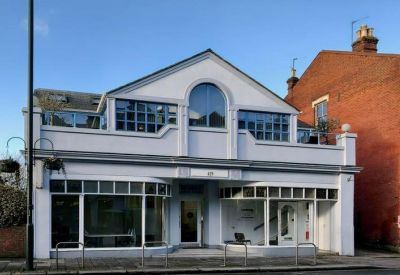 Exterior view of the light-colored Hung Kuo Building facade with large windows.