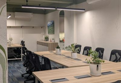 Spacious co-working area at ICICI Bank, 2nd Floor, Sai Enclave with wooden desks and indoor plants.