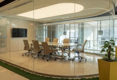 Modern glass-enclosed conference room with a large white table and ergonomic seating.