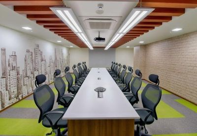 Long formal meeting room with city skyline wallpaper and green ergonomic chairs.