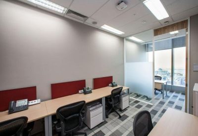 Internal office suite featuring linear workstations with red dividers and grey carpeting.