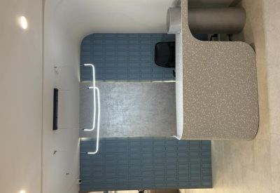 Reception desk area with a textured front and blue sound-dampening wall panels.