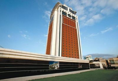 Exterior view of the modern high-rise Flora Suite Office with its distinctive white and orange facade.