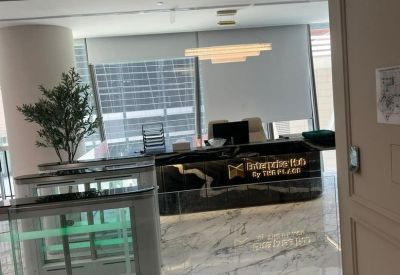 Sophisticated marble reception desk with the Enterprise Hub logo and soft lighting.