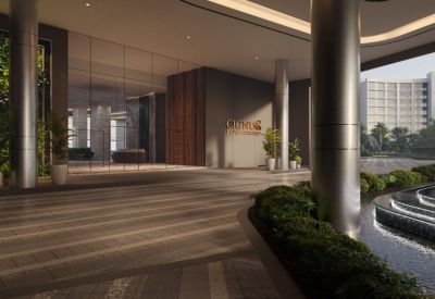 Modern lobby entrance with polished stone floors, sleek pillars, and a decorative water feature.