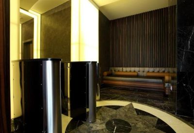 Sleek lounge area with dark wood paneling, recessed lighting, and comfortable seating.