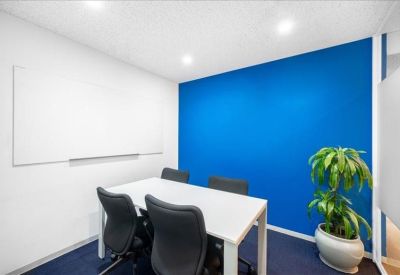 Meeting room with blue feature wall and whiteboard.