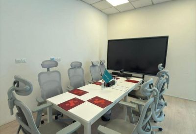 Professional conference room with a digital screen and seating for eight.