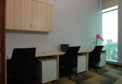 Three-person workstation setup with overhead cabinetry and ergonomic black chairs.