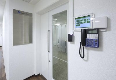 Secure entrance with digital keypad and telephone intercom.