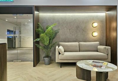 Cozy lounge area with a light grey sofa, round coffee table, and integrated wooden shelving.