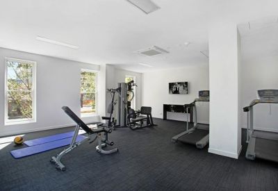 Spacious gym area with treadmills and weight machines.