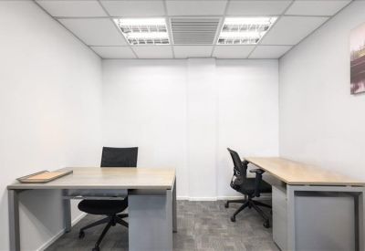Bright workspace featuring two separate desks and air conditioning unit.