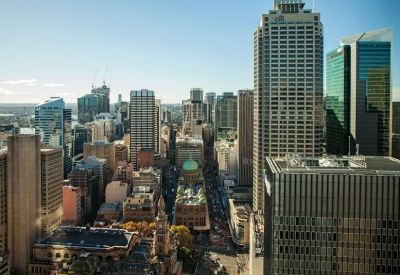 High-angle view of the dense Sydney CBD skyline featuring a mix of modern and heritage architecture.