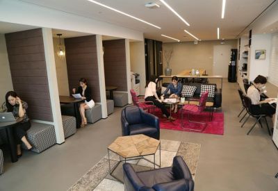 Spacious communal lounge with diverse seating and working pods.