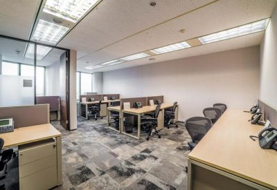 Private office suite with multiple workstations and grey carpeting.