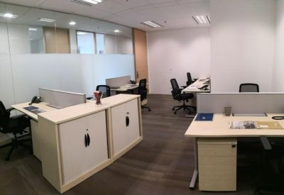 Professional workspace area with built-in storage cabinets and partitioned desks.
