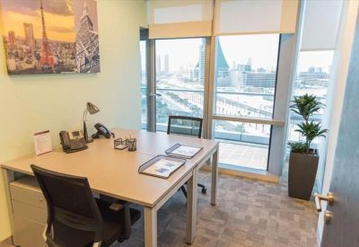 Office with a desk, chair, and large windows offering city views.