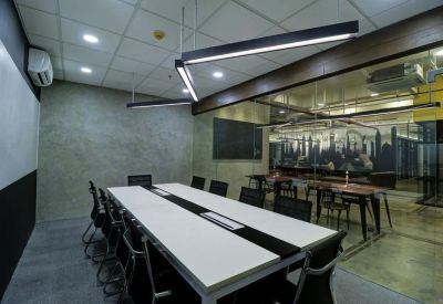 Modern conference room with a long white table and linear LED lighting.
